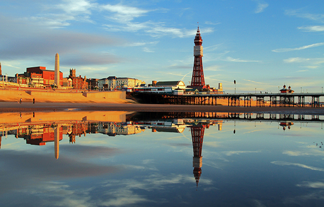 A Fylde Coast Golden Hour Reflection of Blackpool Tower and North Pier on a calm still early evening glow.