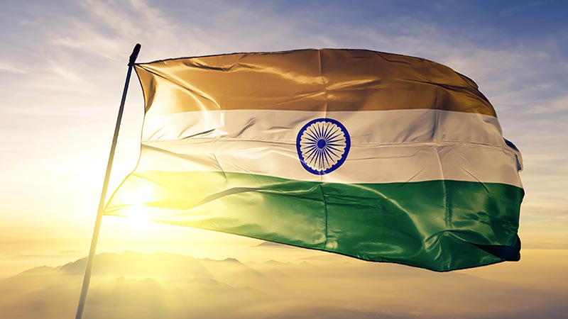 India Indian flag on flagpole textile cloth fabric waving on the top sunrise mist fog