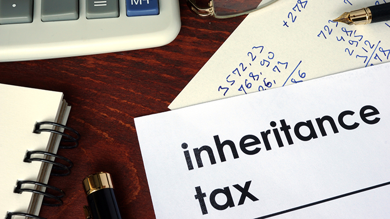 Inheritance tax written on a paper. Financial concept.