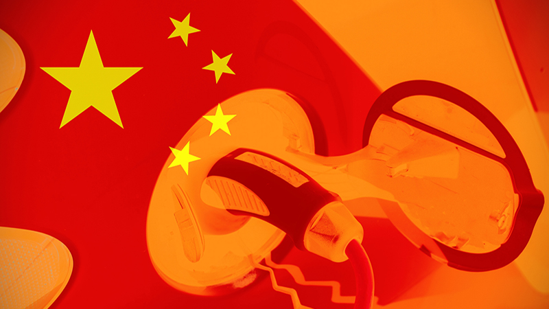 Close up view of an electric car with the Chinese flag as background. Concept of electric cars in China or Chinese car industry.