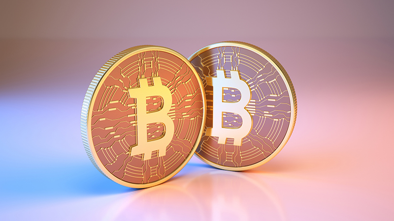 3d render Bitcoin digital currency sitting on metallic blue and pink background (Close-up)