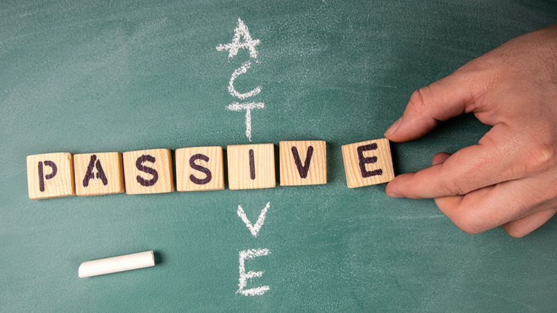 Passive and Active. Text from letters of the wooden alphabet on a green chalk board