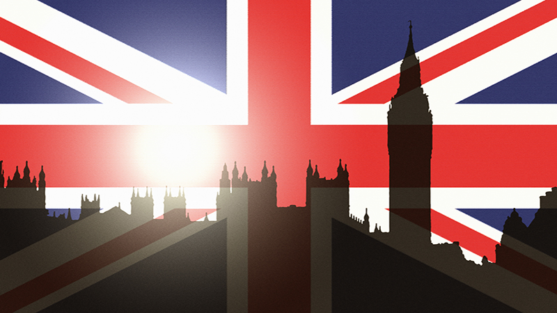 UK politics and government concept: silhouette of parliament buildings and Big Ben projected onto the Union Jack, UK national flag; the sun setting over parliament.