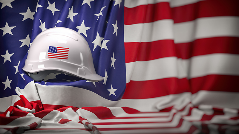 White hard hat laying over USA flag. Construction and employment in United States USA concept, Labor day. 3d illustration