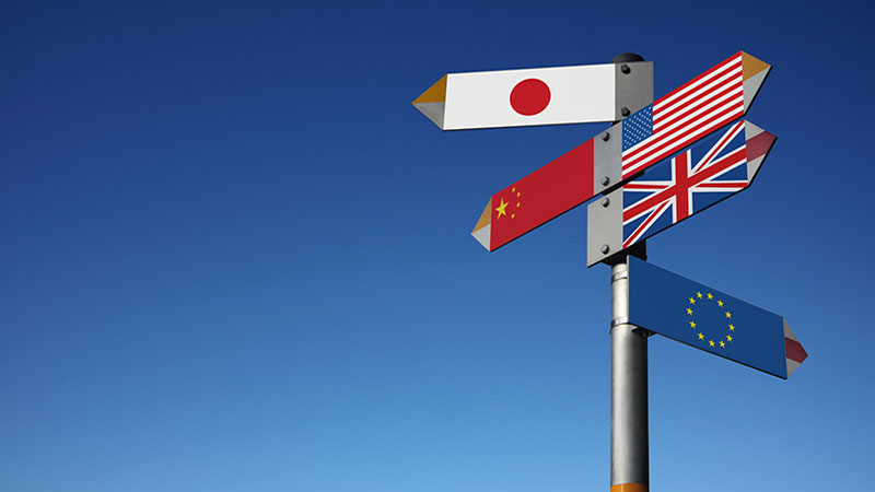 "Signpost with Flag of Japan, China, USA, Great Britain and European Union"