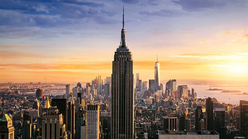 New York City skyline with urban skyscrapers at sunset, USA.