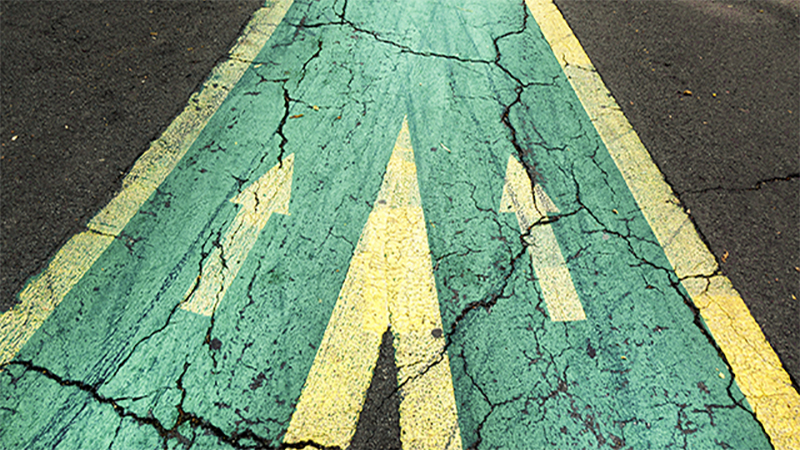 Close up arrow signs on asphalt city road